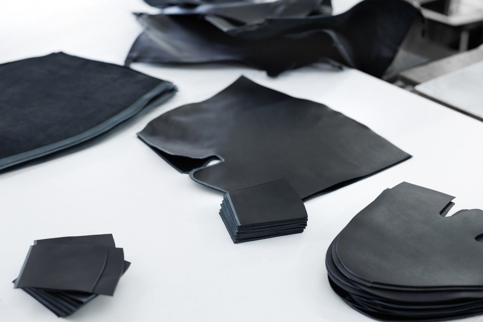 Pieces of leather are lying on the table. Blanks for the manufacture of shoes. Pieces of leather are lying on the table. Blanks for the manufacture of shoes.